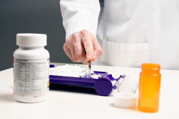 Pharmacist counting prescription pills 