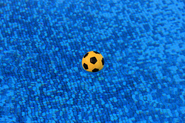 Fototapeta na wymiar water polo ball on the surface of the pool