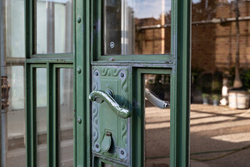 closeup of iron door handle painted green, like many other urban elements from the secession era in Vienna