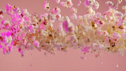 Falling popcorn, isolated on pink background.