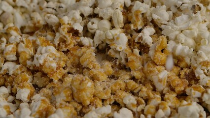 Pouring caramel over white popcorn