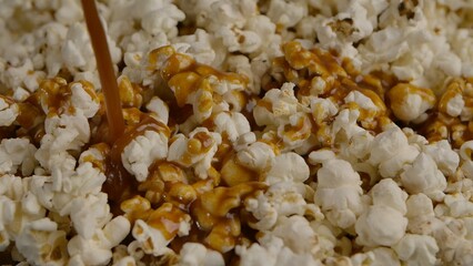 Pouring caramel over white popcorn