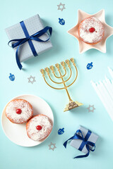 Traditional Hanukkah celebrations elements on blue background. Flat lay, top view.