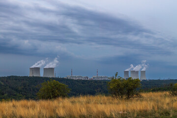 Dukovany nuclear power plant in the Czech Republic, Europe. Smoke cooling towers. There are clouds...