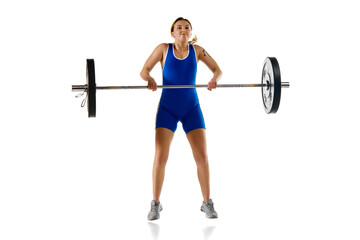 Young athletic girl, weightlifter training, lifting heavy weight, barbell against white background. Concept of sport, strength, gym, healthy lifestyle, power and endurance, weightlifting.