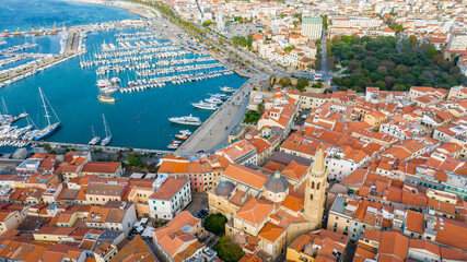 Aerial view of the old town of Alghero in Sardinia. Photo taken with a drone on a sunny day. Panoramic view of the old town and harbor of Alghero, Sardinia, Italy.