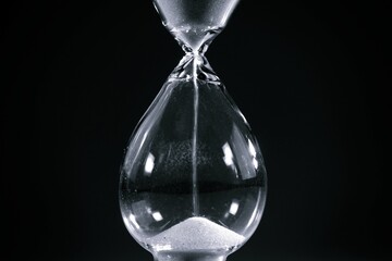 Hourglass. Sands move through hour glass. Close up. Pass of time and waste time concept