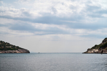 Fototapeta na wymiar Sea horizon between two islands with a surfer
