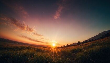  the sun is setting in the sky over a grassy field with a hill in the distance in the distance is a field of grass and a hill in the foreground is in the foreground.