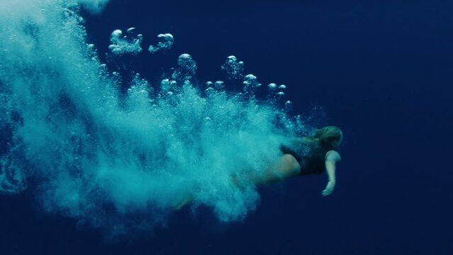 Woman jumps into the sea from a boat