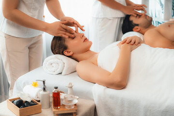 Caucasian couple enjoying relaxing anti-stress head massage and pampering facial beauty skin...