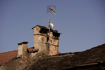 A centuries-old Italian chimney on an old roof
