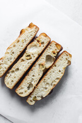 cross-section of homemade olive focaccia on a white background, Flatlay of focaccia with green olive topping, fresh homemade focaccia bread	