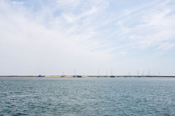 Boat on the Bay with Clear Blue Sky Reflecting on the Calm Water