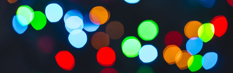 Banner. Colourful festive bokeh lights on background. Abstract multicolored light. Christmas or New Year holiday concept. Mock up template for greeting card