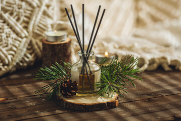 Home aromatherapy with pine cedar oil extracts, essential oil, extract, essence on wooden table....