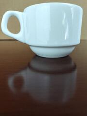 Mug of coffee on the polished wooden table
