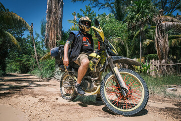 Adventure rider off road travel in to jungle with motorcycle endure bike packing 