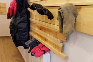 Gloves and socks used in the snow and wet, on the home heating radiator drying