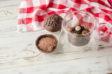 Chocolate bomb with cocoa powder and mini marshmallow to prepare a fragrant hot drink. Process of cooking.