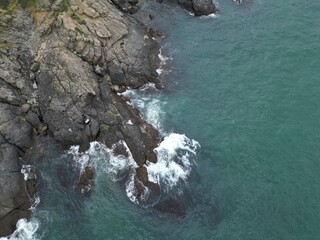 sea cliff in blue water - drone aerial shot for background