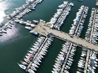 rows of boat yachts in blue water.