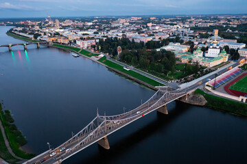 Summer aerial view of modern Tver cityscape overlooking Transfiguration Cathedral and Imperial Traveling Palace on bank of Volga river at dusk, Russia