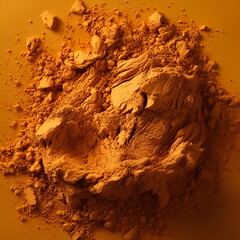 A pile of orange powder pigment on an orange background