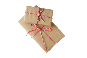 Two Christmas and New Year gift boxes wrapped in brown craft kraft paper with red and white baker's twine, ribbon bow isolated on white, transparent background, PNG