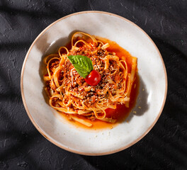 Pasta in Bolognese sauce with ground meat - Recipe served at the table