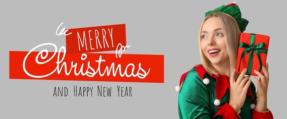 Greeting banner with young woman in elf costume holding Christmas gift