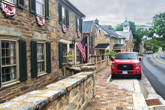Ford F-150 pickup truck is parked on the side of the road in an ancient city.