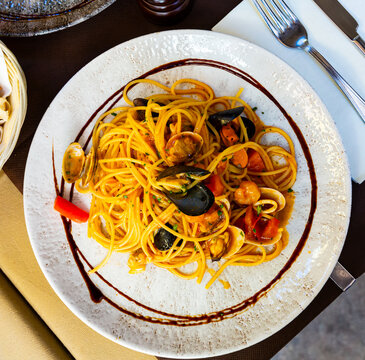 Appetizing spaghetti al Frutti di Mare (seafood spaghetti) - traditional italian pasta with shrimps, squid and mussels
