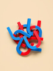 Horseshoe shaped magnets on beige background