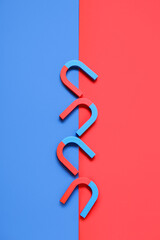 Horseshoe shaped magnets on color background