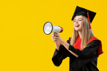 Female graduate student shouting into megaphone on yellow background