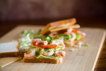 sandwich with lettuce and shrimp.