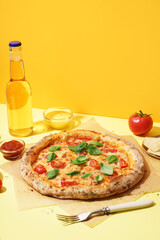 Baking paper with tasty pizza Margarita and basil on yellow background