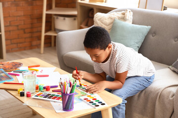 Little African-American boy drawing at home
