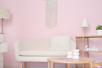 Interior of stylish living room with white sofa, coffee table and shelving unit