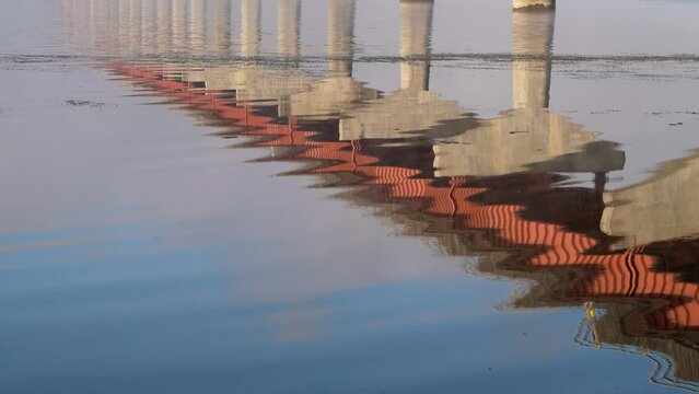 water reflections of a bridge over Tennessee River from Tennessee to Alabama, foggy November sunrise - Natchez Trace National Parkway 