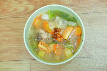 warm vegetable soup in a green bowl
