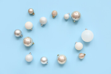 Frame made of Christmas balls on blue background