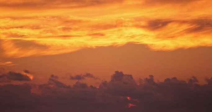 Fiery sunset sky clouds abstract time laps background, global warming or cliamte change video footage timelaps, high quality cinematic natural shot, vivid bright colors sunsets moving. Empty space