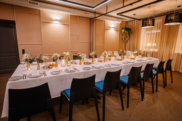 a long table served with dishes and flowers.