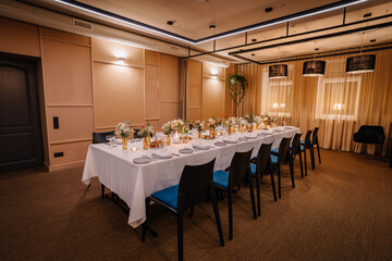 a long table served with dishes and flowers.