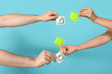 Woman and man with condoms on blue background