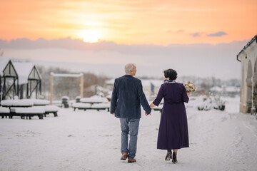 A winter wedding features a radiant senior bride and groom, a mature couple celebrating their love...