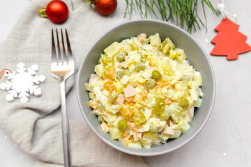 Olivier salad,Christmas food.salad with chicken and vegetables,pea.Traditional ukrainian slavic appetizer for celebrating new year's eve. Festive table setting with decoration