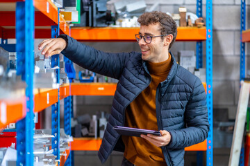 Proud engineer in the stock room of a cnc factory